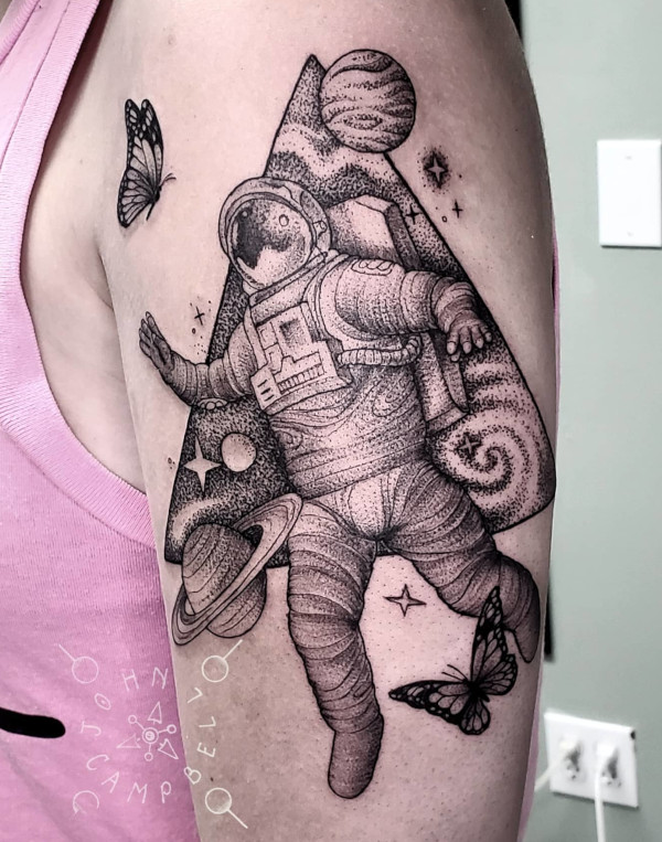 Astronaut with butterflies in space black and grey dotwork tattoo by John Campbell at Sacred Mandala Studio tattoo parlor in Durham, NC.